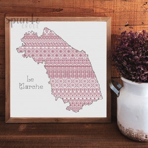 May include: A cross-stitch pattern of the region of Le Marche in Italy, framed in a light brown wood frame. The pattern is a burgundy colour on a white background.