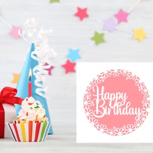 May include: A pink card with a white circle and the text "Happy Birthday" in a white cursive font. The circle is surrounded by a white daisy chain.