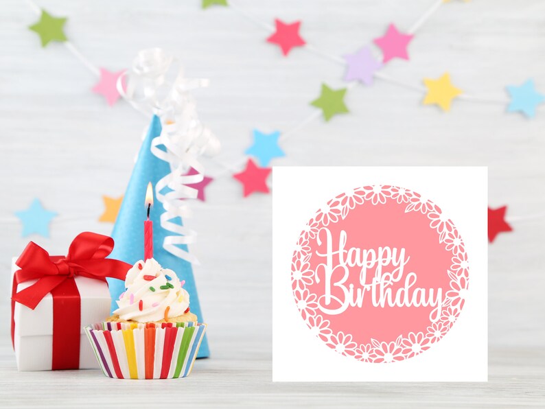May include: A pink card with a white circle and the text "Happy Birthday" in a white cursive font. The circle is surrounded by a white daisy chain.