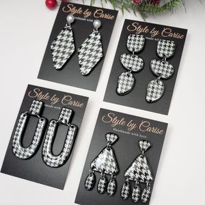 May include: Four sets of black and white houndstooth patterned earrings on black card stock with the text "Style by Carise" and "Handmade with love".