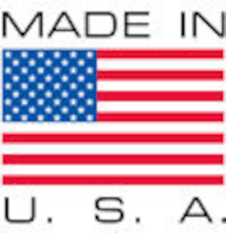 May include: A rectangular sticker with the text "MADE IN U.S.A." and a depiction of the American flag. The flag features a blue field with white stars and red and white stripes.
