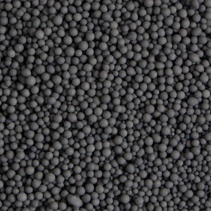 May include: A close-up image of a large quantity of small, black, round pellets. The pellets are uniform in size and shape, and they appear to be made of a hard, durable material.