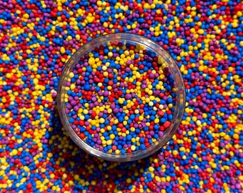 Wiggles kids themed birthday party cartoon musical edible nonpareil sprinkles red yellow purple blue fun bright vibrant cake cupcakes baking