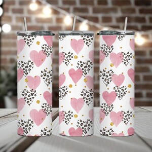 May include: Three stainless steel tumblers with pink and black leopard print hearts and gold glitter accents.
