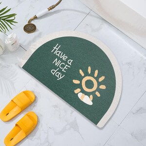 May include: A green and white half-circle doormat with the text "Have a Nice Day" and a yellow sun with a white cloud.