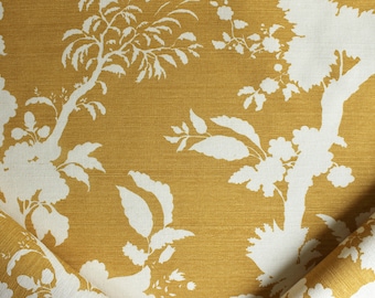 May include: A close-up of a fabric with a white floral pattern on a mustard yellow background. The fabric is folded in half, showing the pattern on both sides.