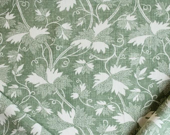 May include: Green fabric with a white floral pattern. The fabric has a textured, linen-like appearance.