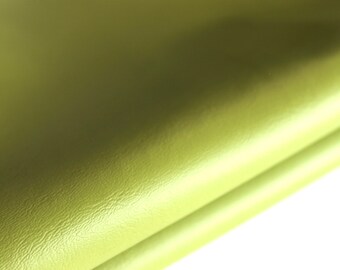 May include: A close-up of a folded piece of light green fabric with a textured surface.