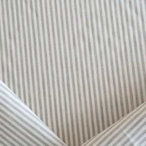 Designer green and white striped linen upholstery fabric by the yard