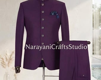 May include: A formal purple suit with a mandarin collar, displayed on a mannequin. The suit includes a matching jacket with a pocket square and trousers. The text "NarayaniCraftsStudio" is visible on the jacket.