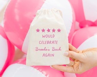 May include: A white drawstring bag with pink stars and text that reads "Would Celebrate Brooke's Bach Again".
