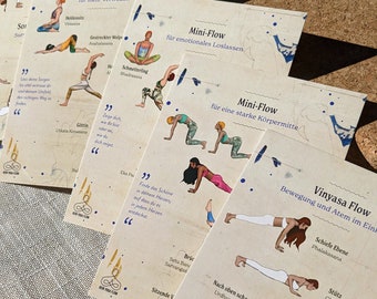 May include: A set of ten illustrated cards featuring different yoga poses. Each card has a title and a description of the pose in German. The cards are printed on a beige background with blue and white accents.