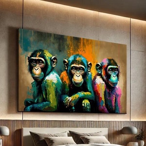 May include: A large canvas print depicting three chimpanzees in vivid colours. The artwork, with green, blue, orange, and pink tones, hangs above a bed in a contemporary bedroom. The print is a striking piece of wall art.