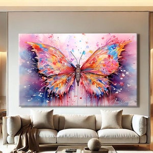 May include: A large, colourful butterfly art print. The artwork depicts a vibrant butterfly with wings in shades of pink, orange, blue, and yellow. The butterfly is set against a soft, watercolour-style background. The artist's signature is visible.