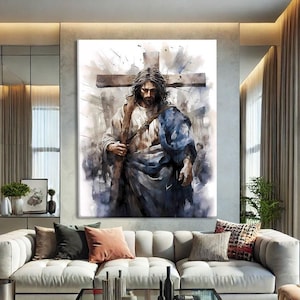 May include: Large watercolor painting of a religious figure carrying a cross. The artwork features a figure in flowing robes, with a cross in the background. The painting is displayed above a white sofa in a modern living room setting.