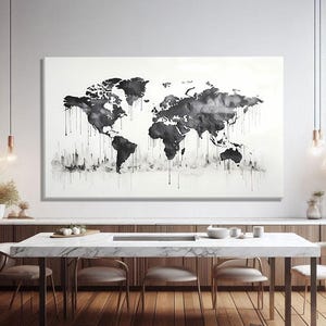 May include: A monochrome world map art print with a watercolour effect. The black continents are set against a white background, with ink drips adding detail. The artwork hangs above a dining table, creating a modern interior design.