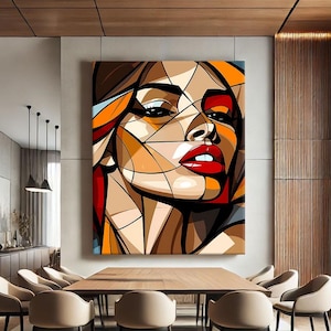 May include: Abstract geometric portrait of a woman with red lips and orange, brown, and yellow colours. The painting is framed and hanging on a wall in a dining room with a wooden table and chairs.