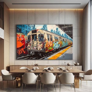 May include: A large canvas print depicting a graffiti-covered subway train in a city setting. The train is painted with vibrant colors and intricate designs. The background features a cityscape with tall buildings and a blue sky. The artwork is displayed above a wooden dining table.