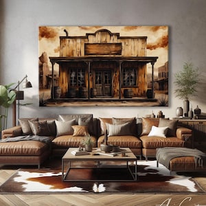May include: A large canvas print of a sepia-toned Western-style building hangs above a brown leather sectional sofa. The artwork depicts a wooden saloon with a sign, barrels, and a desert landscape. The room includes a cowhide rug and a wooden coffee table.