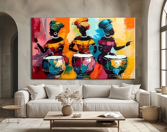 May include: Three women in colourful clothing and headwear play drums. The drums are decorated with bright colours and patterns. The background is a vibrant yellow, orange and red.