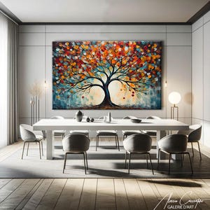 May include: Large abstract tree painting with a vibrant display of colors, including orange, red, and blue. The artwork is displayed above a white dining table with gray chairs. The painting's style is impressionistic, with visible brushstrokes.