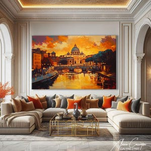 Peut inclure: Grande toile encadrée représentant une ville avec un bâtiment en dôme, probablement une cathédrale, se reflétant dans l'eau. L'œuvre utilise des tons chauds d'orange et d'or, évoquant un coucher ou lever de soleil. Le tableau est au-dessus d'un canapé beige.