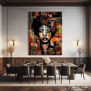 May include: Large abstract artwork depicting a woman's face against a collage of text and colours. The art piece features a black and white face with orange, green, and red accents. The artist's signature is visible in the bottom right corner.