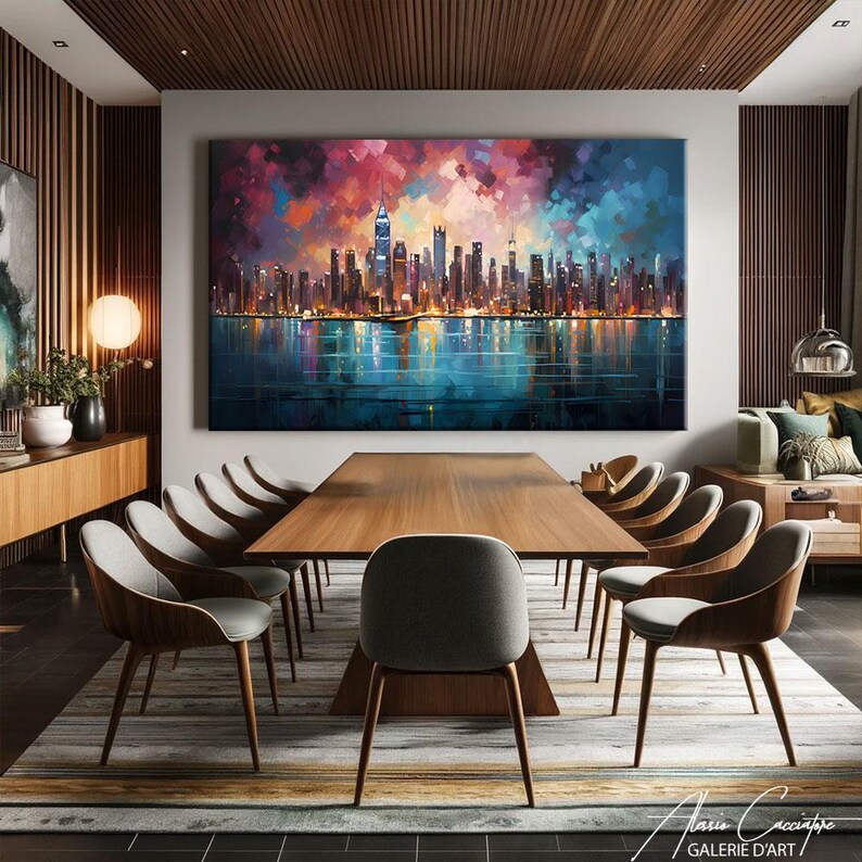 NYC skyline canvas print featuring a stunning panoramic view of Manhattan's illuminated skyscrapers at night reflected on a calm teal water surface, set beneath a dramatic mosaic-style expressionist sky of deep red, purple, rose and electric blue palette knife brushstrokes creating a vibrant jewel-toned canopy above the glittering city lights. Bold cubist-inspired painting style with rich multicolored tones on a dark background. Premium fine art canvas handcrafted in Germany.