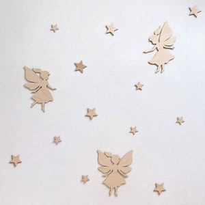May include: A set of wooden fairy and star wall decor. The fairies are in a flying pose with wings outstretched. The stars are five-pointed and scattered around the fairies.