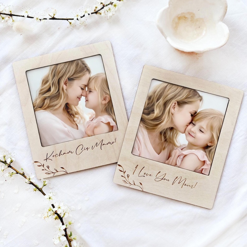 Custom magnetic frames with engaving laying on the white blanket.