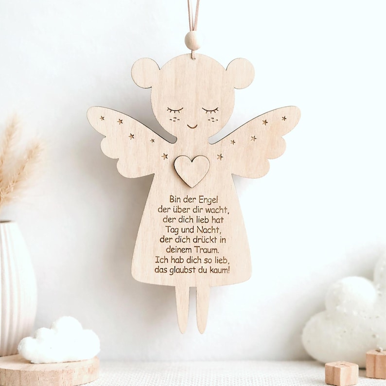 Wooden guardian angel with engraved prayer hanging on a wall in a child`s room.