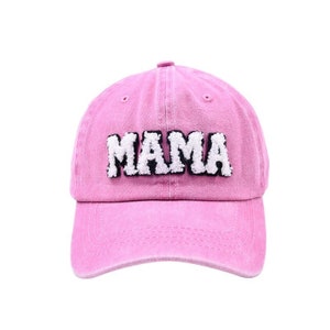 May include: Pink baseball cap with white fuzzy lettering that says "MAMA"