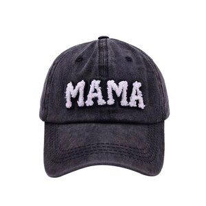 May include: A black denim baseball cap with a white fuzzy "MAMA" embroidered on the front.
