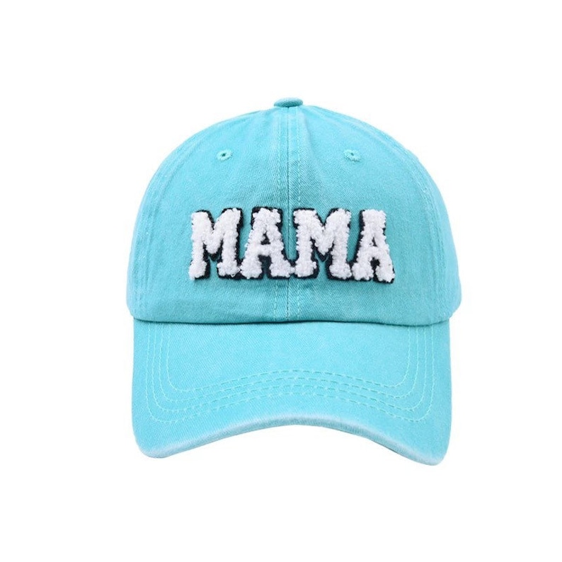 May include: A turquoise blue baseball cap with a white and black embroidered "MAMA" on the front.