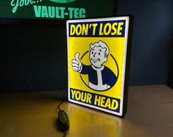 Lámpara Fallout Don't Lose Your Head - Póster Vaultboy - Caja de luz LED, ideal tanto para pared como para cabecera.