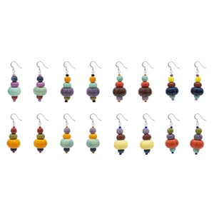 May include: Set of 12 pairs of colorful ceramic bead earrings. Each earring features a stack of four round beads in various colors, including purple, green, orange, yellow, brown, and blue.