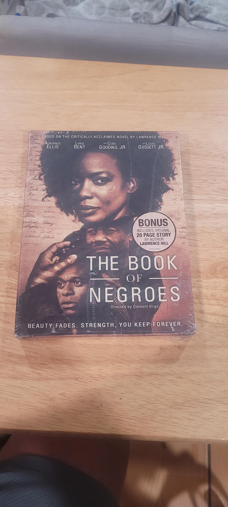 May include: DVD of "The Book of Negroes" based on the novel by Lawrence Hill, featuring Aunjunue Ellis, Lyriq Bent, Cuba Gooding Jr., and Louis Gossett Jr. The cover displays portraits of the actors and the text "Beauty Fades. Strength, You Keep Forever."