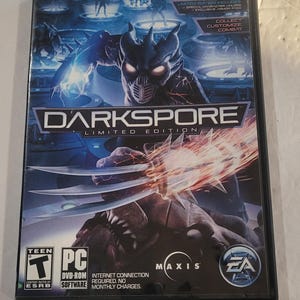 May include: Darkspore Limited Edition PC game. The cover features a futuristic warrior with glowing eyes and a weapon, set against a blue and orange background. The game is rated Teen by ESRB.