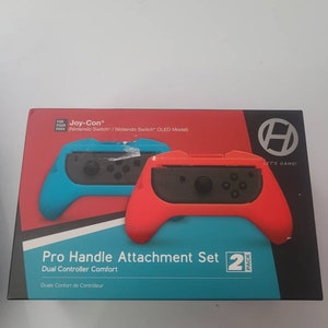 May include: A two-pack set of red and blue Joy-Con Pro Handle Attachments for the Nintendo Switch and Switch OLED. The packaging features the text "Let's Game!" and "Pro Handle Attachment Set 2 Pack".