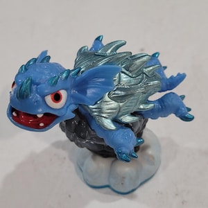 May include: A white ceramic mug with a black cat illustration and the text "Crazy Cat Lady". The mug has a black handle and a glossy finish. The cat illustration features a whimsical design.