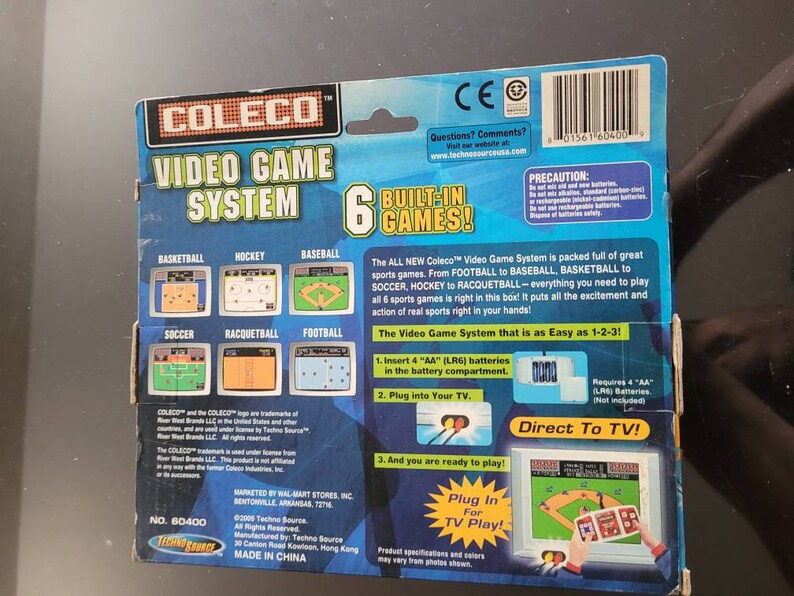 May include: A Coleco Video Game System with six built-in games: Basketball, Hockey, Baseball, Soccer, Racquetball, and Football. The system is blue and yellow and features a plug-in for TV play. The box includes instructions for setting up the system and requires four AA batteries (not included).