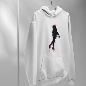 May include: White hoodie with a black and red silhouette of a person jumping in mid-air. The silhouette is painted with a dripping effect.