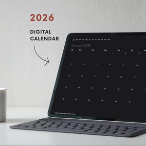 May include: A digital calendar for 2026 displayed on a tablet with a keyboard. The screen shows a black background with a January 2026 calendar layout. The text "2026 DIGITAL CALENDAR" is in the upper left corner.