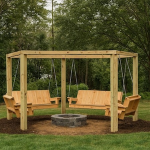 May include: Wooden swing set with two swings, each with a backrest and armrests, suspended from a wooden frame. A small fire pit is centered below the swings. The structure is set in a grassy area with trees in the background.