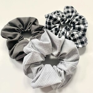 May include: Three fabric scrunchies in grey, white with black polka dots, and black and white gingham.