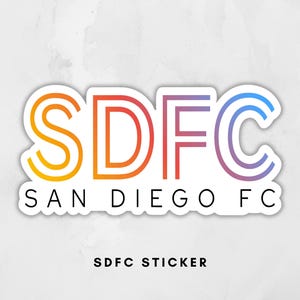 May include: A white sticker with the text "SDFC" in a gradient of orange, red, purple, and blue. Below, the words "SAN DIEGO FC" are in black, with "SDFC STICKER" below that.
