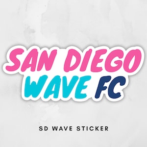 May include: A white sticker with the words "SAN DIEGO WAVE FC" in pink, blue, and navy blue, with a white outline. The text "SD WAVE STICKER" is below the main text.