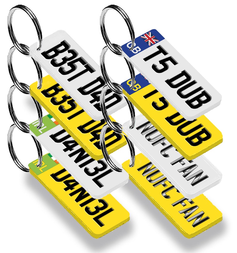 May include: A set of six keychains with different designs. Each keychain features a white rectangular tag with black text and a yellow background. The tags have different text, including "Best Dad", "T5 DUB", "I3 DUB", "NUFC FAN", and "D4N13L".