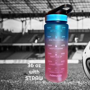 May include: A 36 ounce water bottle with a straw and a motivational time tracker. The bottle is blue and pink with a black lid and handle. The time tracker has motivational phrases like "Get Started" and "Keep Chugging".