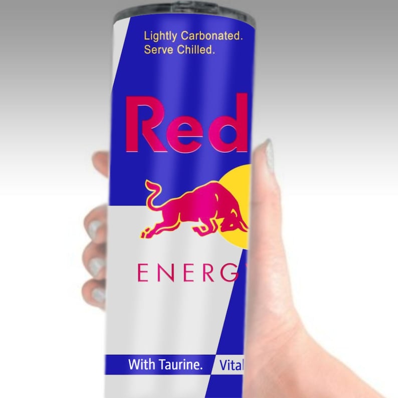 May include: A red and blue can with a red bull logo and the text "Red Bull Energy Drink" and "Lightly Carbonated. Serve Chilled."  The can also has the text "With Taurine. Vital" at the bottom.